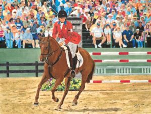 woman riding horse before a crowd equestrian competition