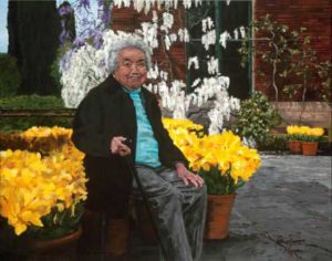 old woman seated on bench in front of yellow flowers