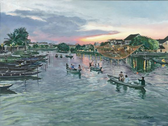 Vietnam river scene with boats on water in foreground and village in background
